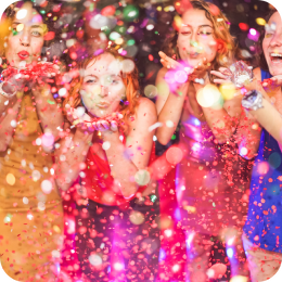 a group of people standing next to a christmas tree
