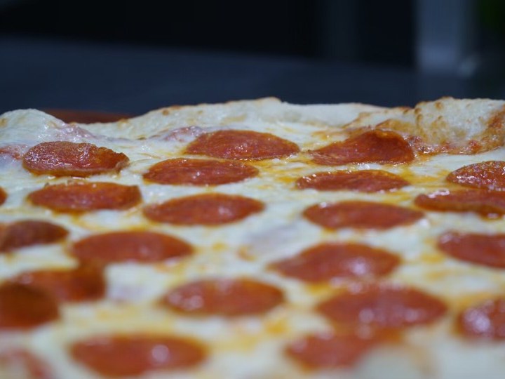 Close-up of a pepperoni pizza with melted cheese and crispy crust.
